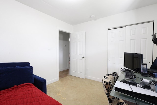 bedroom featuring light carpet and a closet