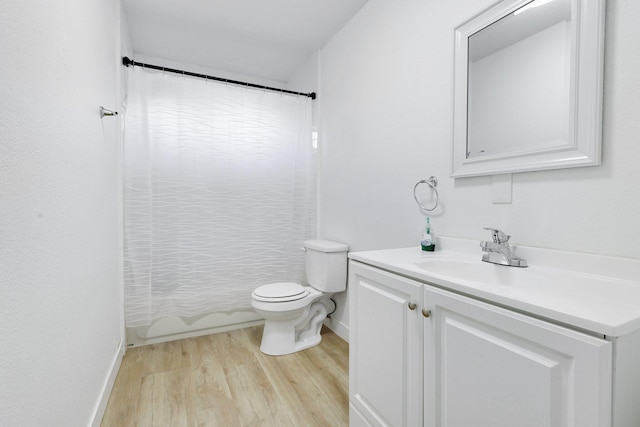 full bathroom with shower / tub combo with curtain, vanity, toilet, and wood-type flooring