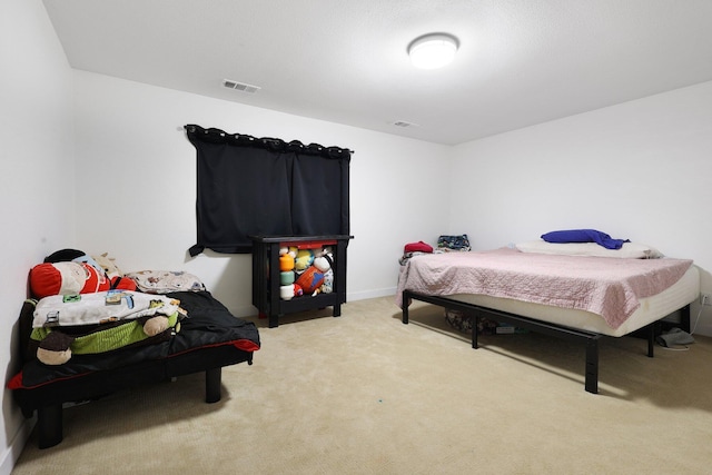 bedroom featuring light colored carpet