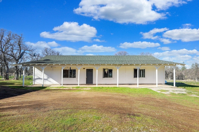 rear view of house featuring a patio area and a lawn