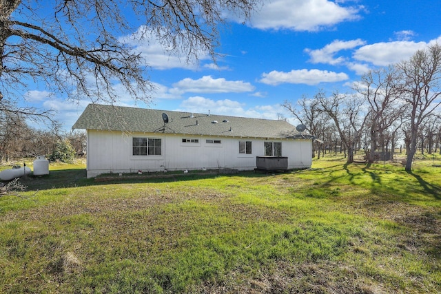 back of property featuring a lawn