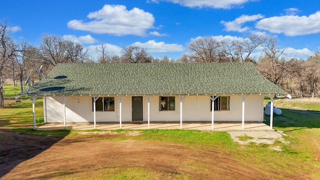 back of property with a yard and a patio