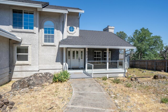 view of exterior entry with covered porch