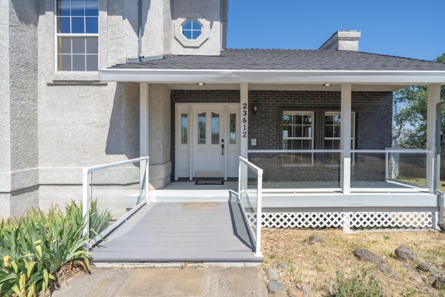 doorway to property with covered porch