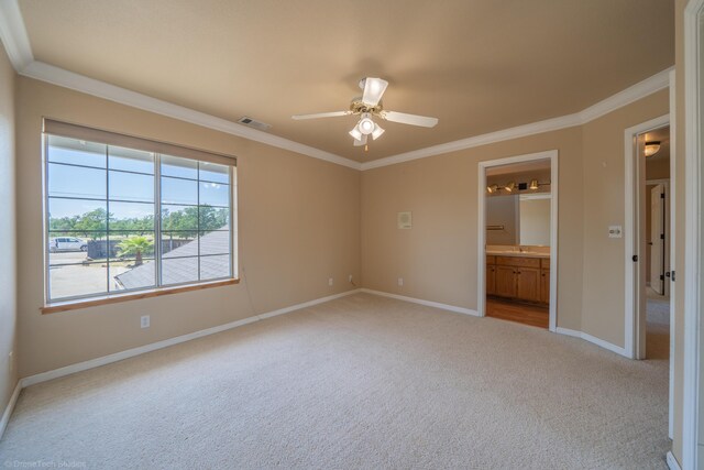 unfurnished bedroom with ceiling fan, ornamental molding, light carpet, and connected bathroom