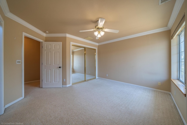 unfurnished bedroom with ceiling fan, light colored carpet, and ornamental molding