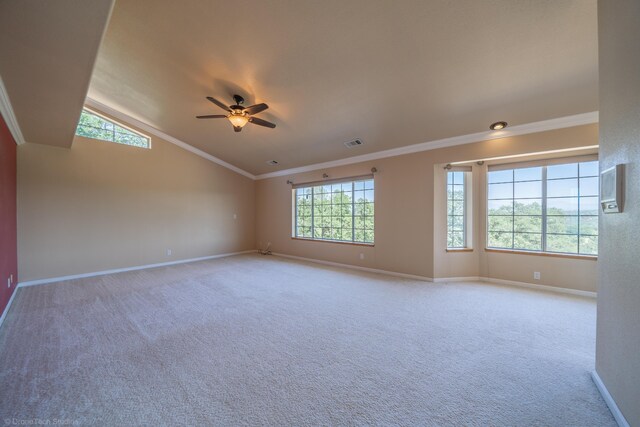 unfurnished room with carpet flooring, vaulted ceiling, ceiling fan, and crown molding