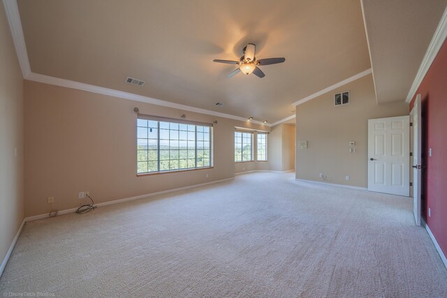 carpeted spare room featuring crown molding, ceiling fan, and lofted ceiling