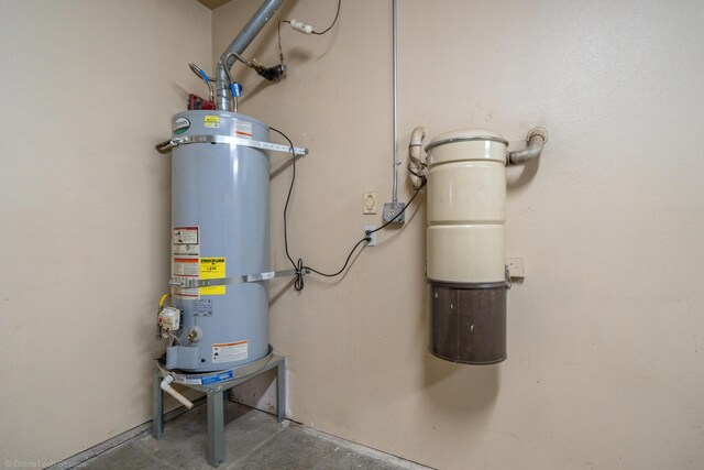 utility room featuring water heater