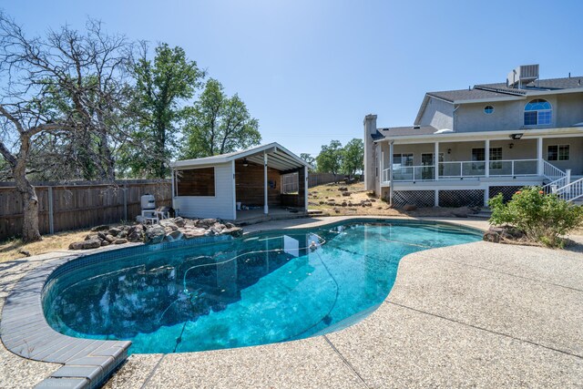 view of swimming pool featuring cooling unit and a patio