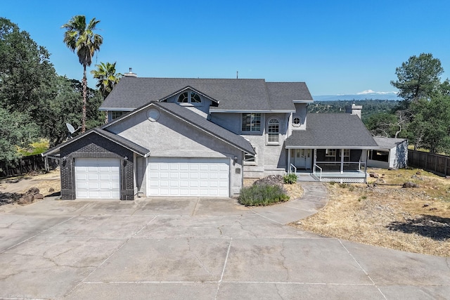 view of property featuring a porch and a garage