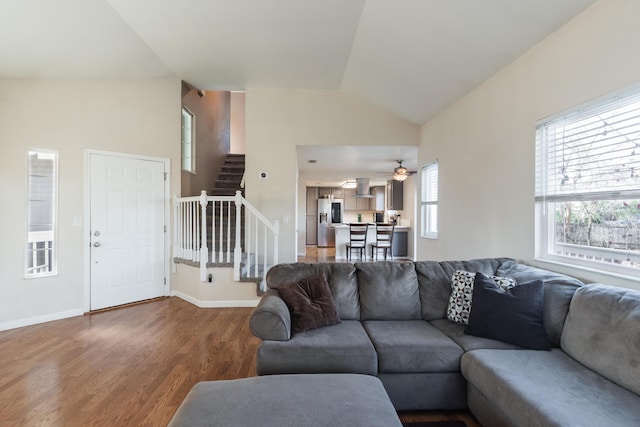 living room featuring hardwood / wood-style floors, ceiling fan, and vaulted ceiling