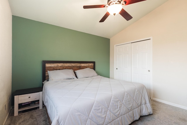 carpeted bedroom featuring ceiling fan, vaulted ceiling, and a closet