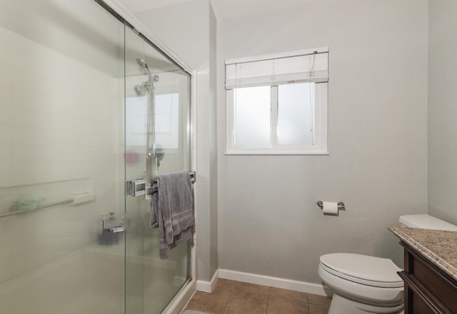 bathroom with tile patterned floors, vanity, an enclosed shower, and toilet