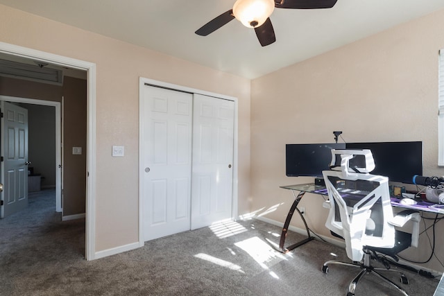 office space with ceiling fan and dark colored carpet