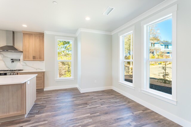 kitchen featuring range, light brown cabinets, dark hardwood / wood-style flooring, wall chimney range hood, and crown molding