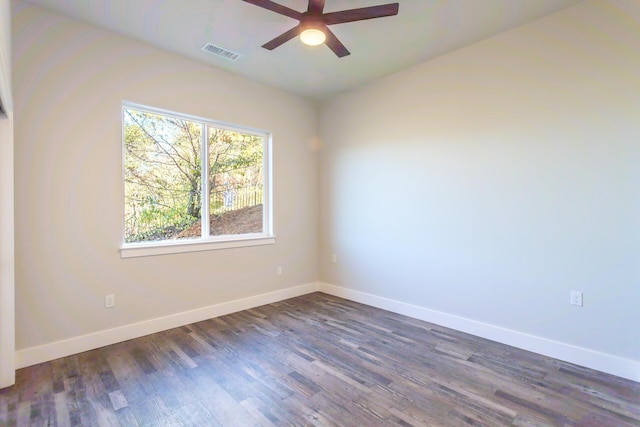 empty room featuring dark wood-type flooring and ceiling fan