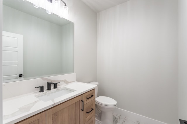 bathroom with toilet and vanity