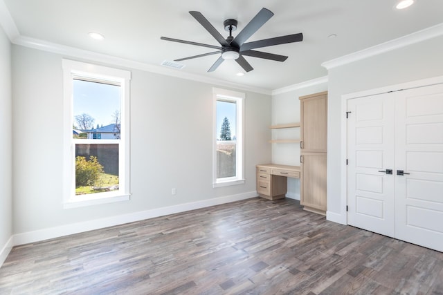 unfurnished bedroom with ceiling fan, multiple windows, and ornamental molding