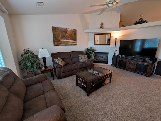 carpeted living room featuring ceiling fan and lofted ceiling