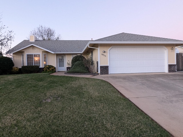 single story home with a yard and a garage