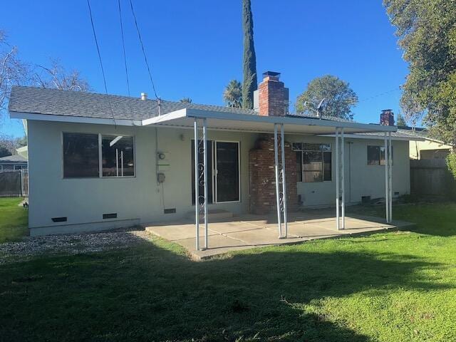 rear view of house with a yard and a patio