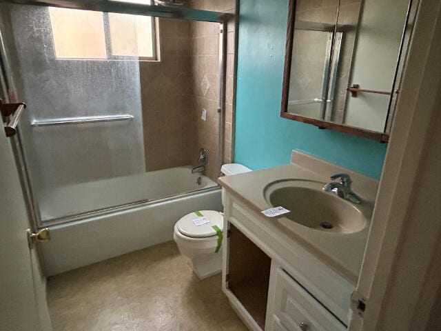 full bathroom with vanity, shower / bath combination with glass door, and toilet