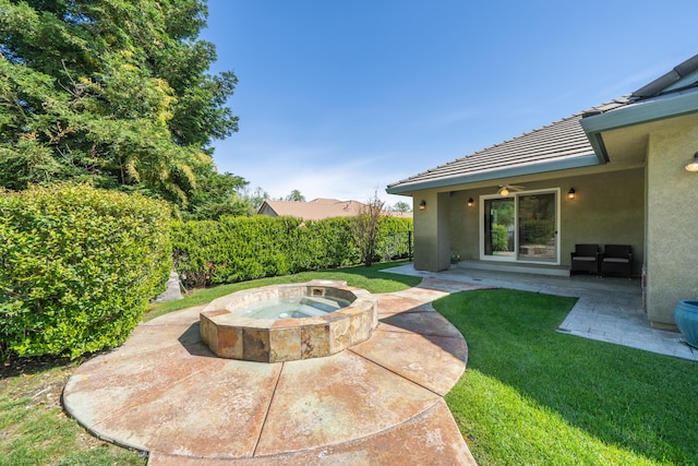 view of yard with ceiling fan and a patio