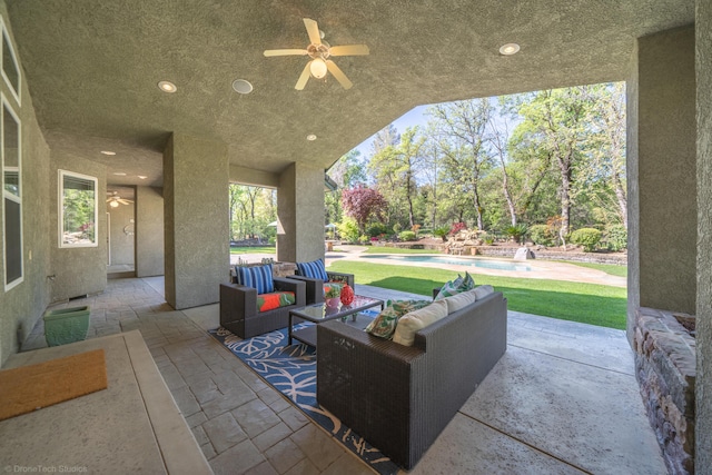 view of patio / terrace featuring ceiling fan and an outdoor living space