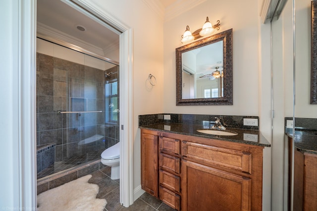 bathroom featuring tile patterned floors, walk in shower, ceiling fan, crown molding, and toilet