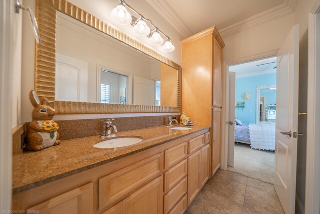 bathroom featuring tile patterned flooring, vanity, and ornamental molding