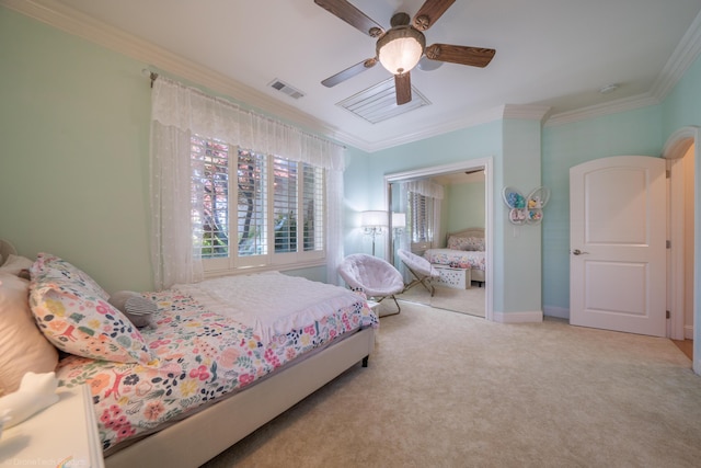 bedroom featuring ceiling fan, crown molding, and light colored carpet