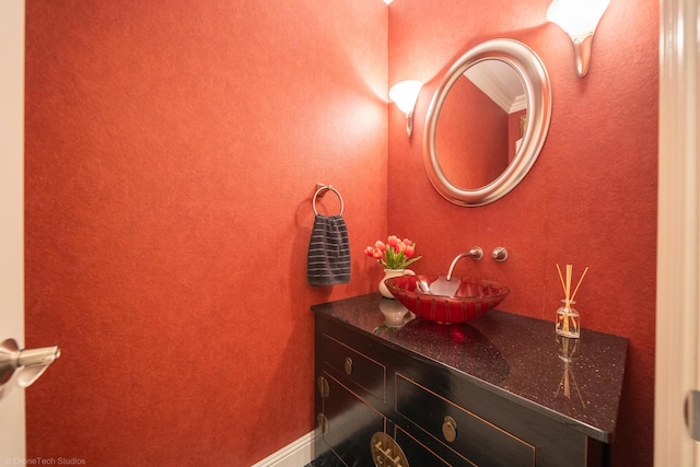 bathroom featuring vanity and ornamental molding