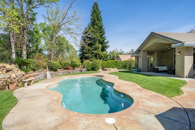 view of pool with a patio and a lawn