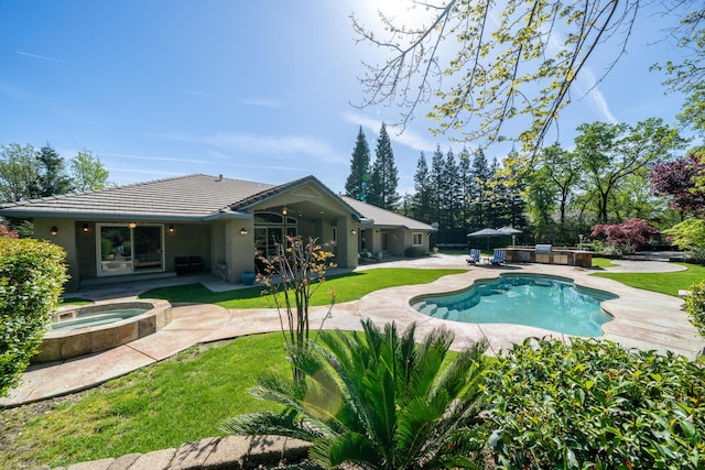 back of house with a lawn, a swimming pool with hot tub, and a patio