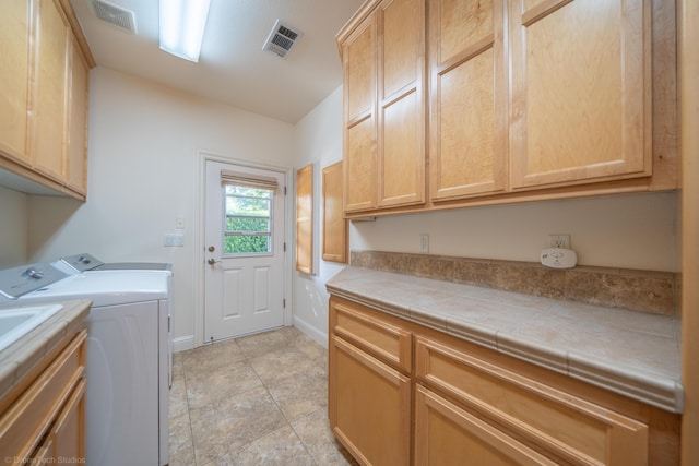 laundry area featuring cabinets and independent washer and dryer