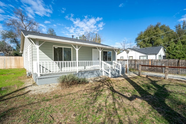 view of front of home featuring a front yard and covered porch