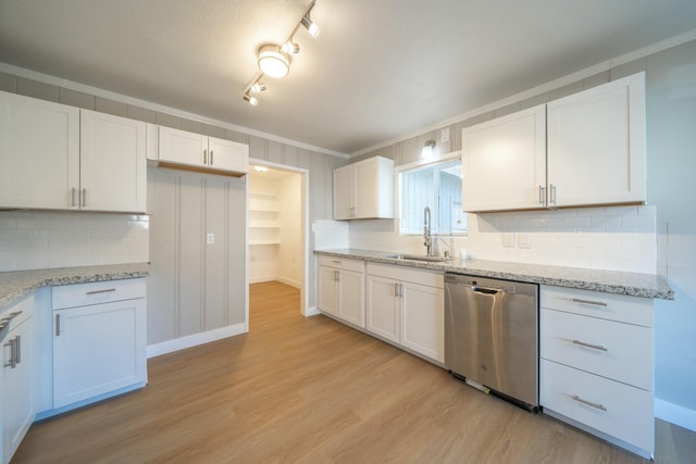 kitchen with white cabinetry, dishwasher, and sink