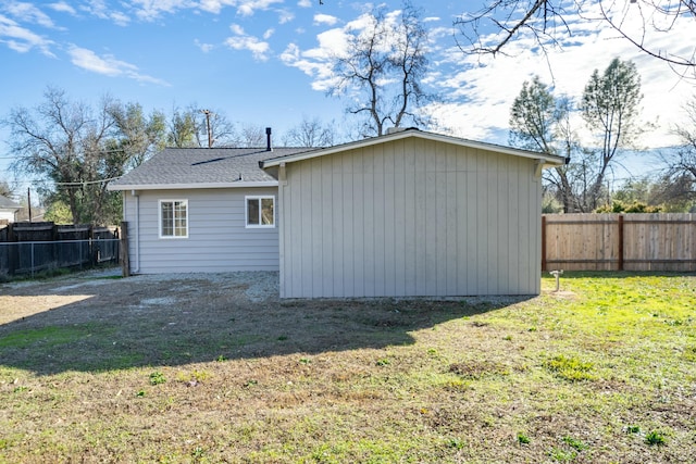 back of house with a lawn