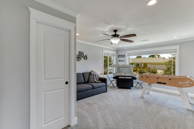 interior space featuring ceiling fan, carpet, and crown molding