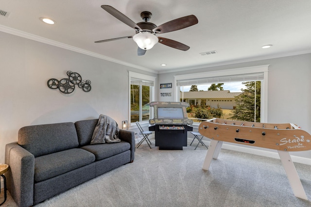 interior space featuring light carpet, ceiling fan, and ornamental molding