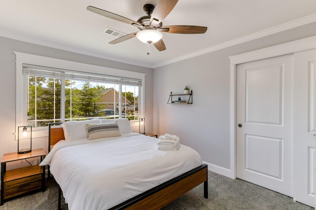 carpeted bedroom with ceiling fan and crown molding