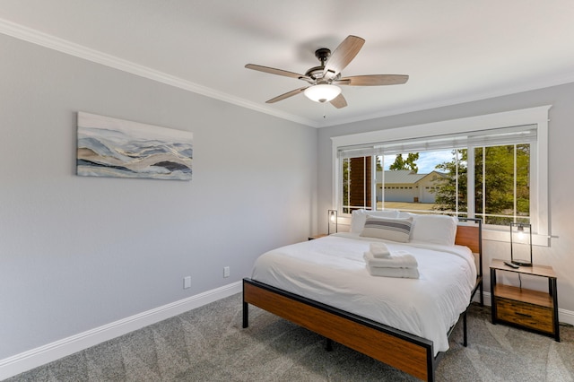 bedroom featuring ceiling fan, ornamental molding, and carpet floors