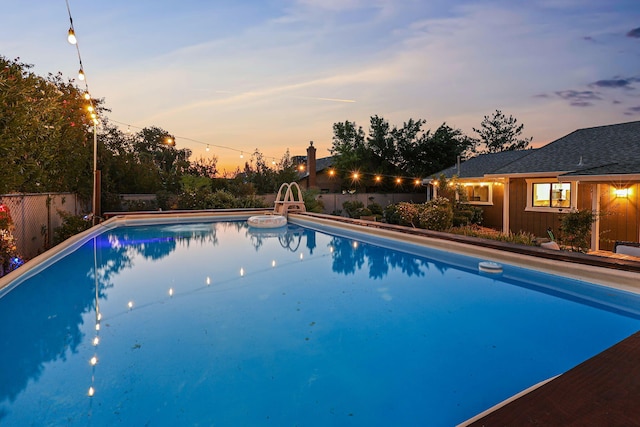 view of pool at dusk