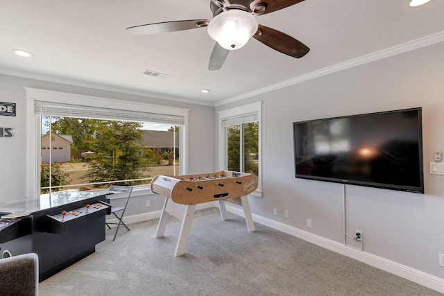 playroom featuring ceiling fan, light colored carpet, and crown molding