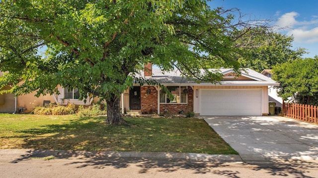 view of front facade with a front yard and a garage