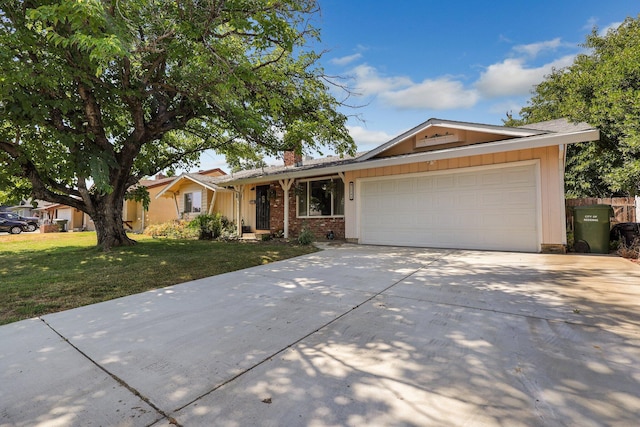 ranch-style house featuring a front lawn and a garage