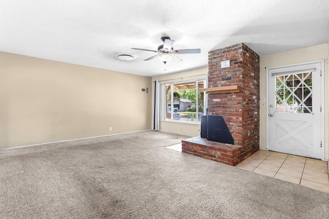 2048 Wilder Dr, Redding, CA 96001 - unfurnished living room featuring a wood stove, carpet floors, plenty of natural light, ceiling fan, and a textured ceiling