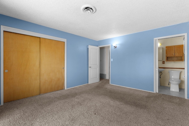 2048 Wilder Dr, Redding, CA 96001 - unfurnished bedroom featuring carpet, a closet, a textured ceiling, and ensuite bathroom
