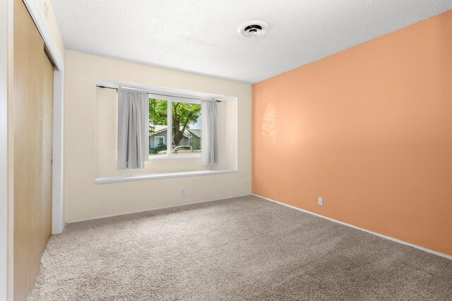 2048 Wilder Dr, Redding, CA 96001 - unfurnished bedroom with a closet, carpet flooring, and a textured ceiling